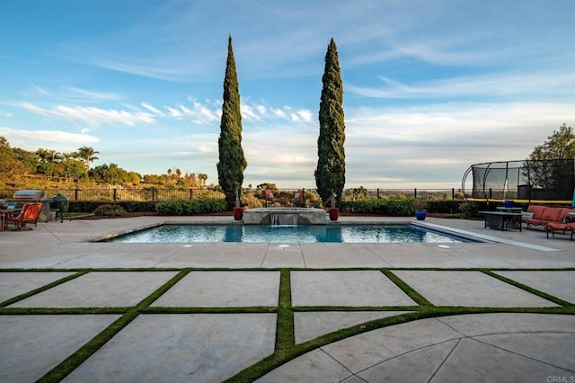 view of pool featuring pool water feature and a patio area