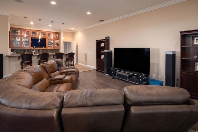 living room featuring wood-type flooring, bar area, and crown molding