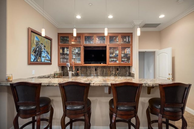 bar with ornamental molding, hanging light fixtures, light stone counters, and tasteful backsplash