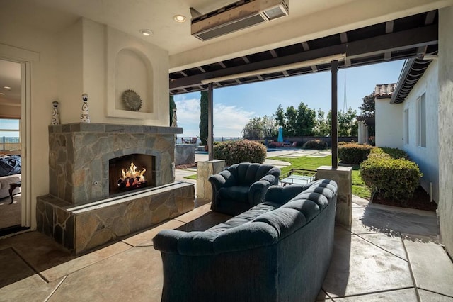 living room with an outdoor stone fireplace