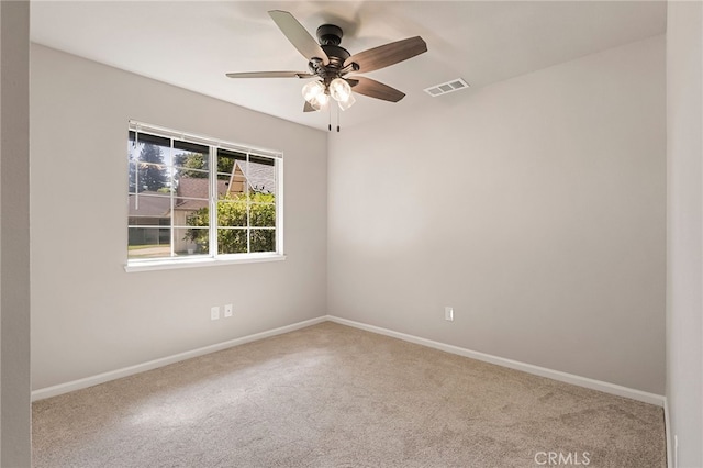 carpeted spare room featuring ceiling fan