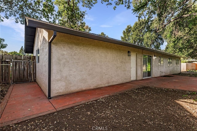 view of side of property with a patio