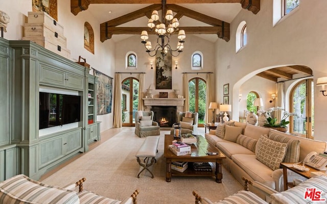 living room with high vaulted ceiling, a healthy amount of sunlight, beamed ceiling, and a chandelier