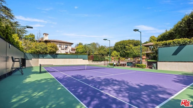 view of sport court with basketball hoop