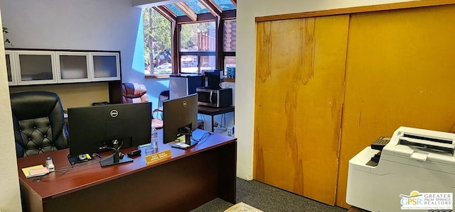 home office featuring dark colored carpet