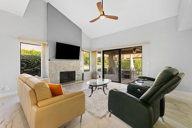 living room with a tile fireplace, ceiling fan, and high vaulted ceiling