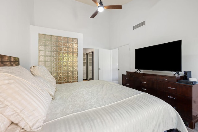 bedroom featuring a high ceiling and ceiling fan