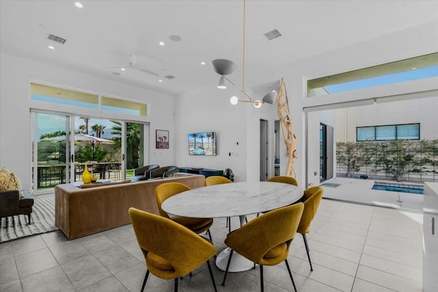 tiled dining area featuring ceiling fan