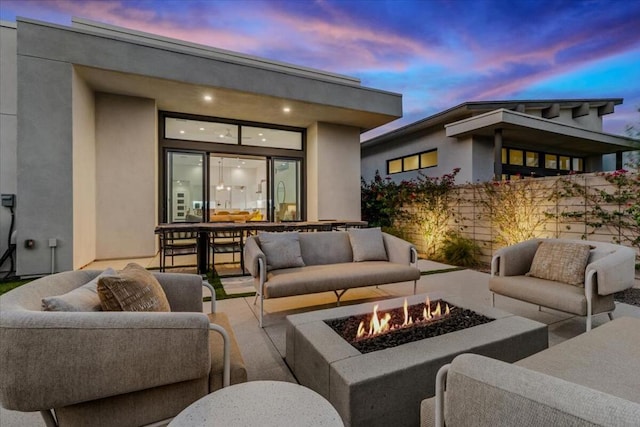 exterior space with an outdoor living space with a fire pit