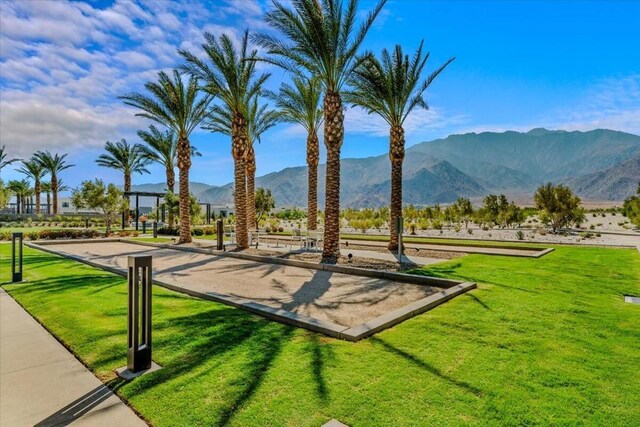 view of community with a mountain view and a yard