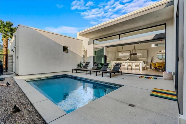 view of swimming pool featuring a patio area