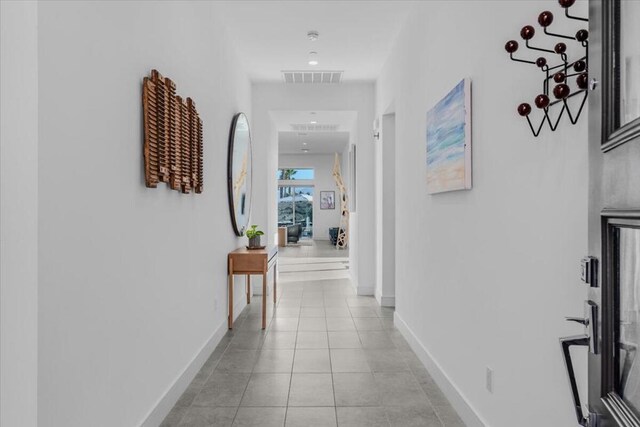 corridor with light tile patterned flooring