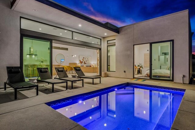 view of swimming pool featuring a patio area and a jacuzzi