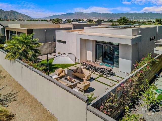 exterior space featuring a mountain view and an outdoor hangout area