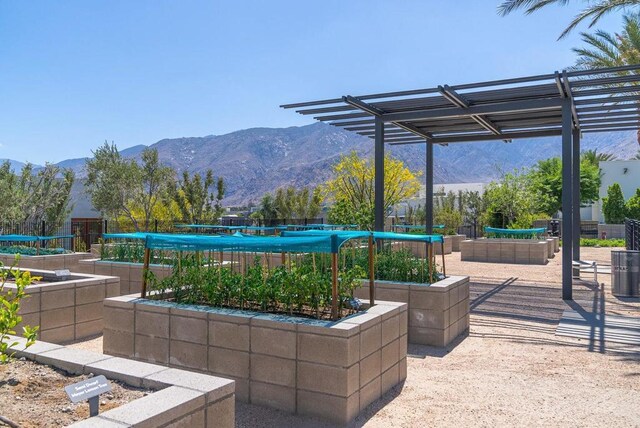 view of property's community with a mountain view and a pergola