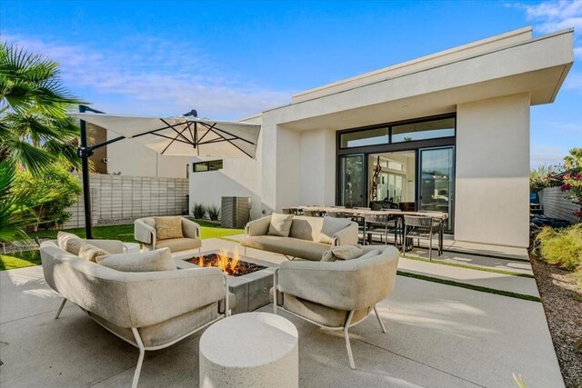 view of patio / terrace featuring an outdoor living space with a fire pit