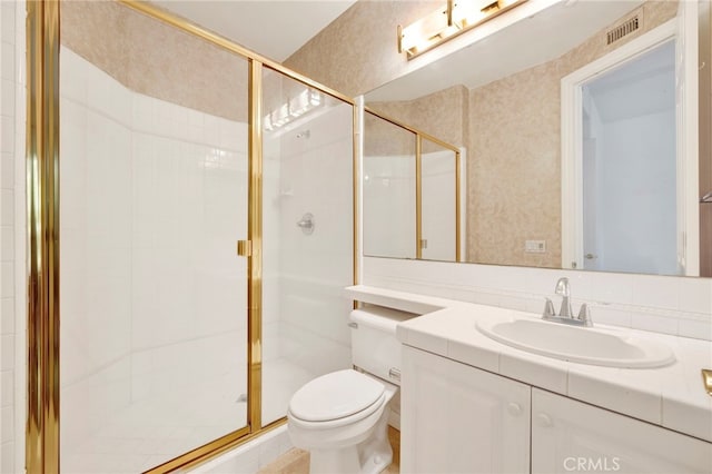 bathroom featuring walk in shower, vanity, and toilet