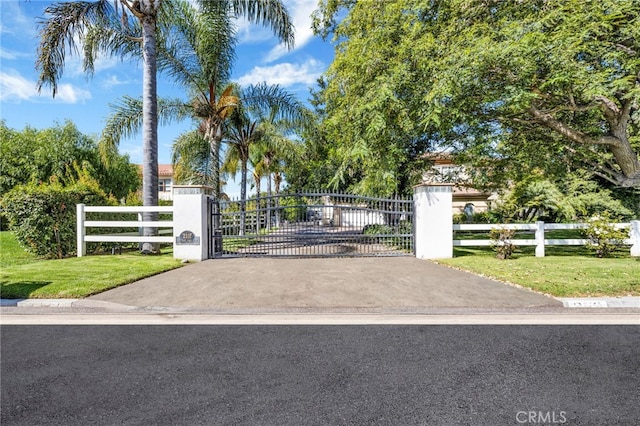 view of gate featuring a lawn