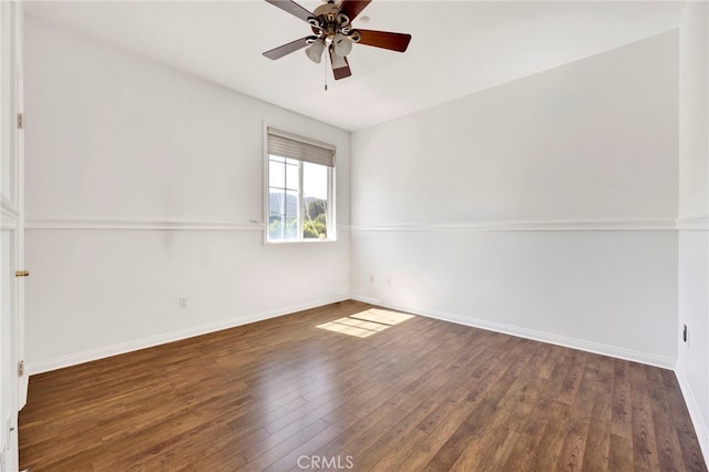 spare room featuring ceiling fan and dark hardwood / wood-style flooring