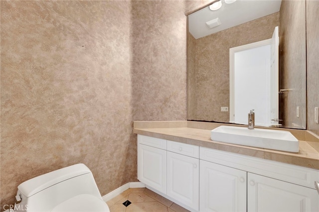 bathroom featuring tile patterned flooring, vanity, and toilet