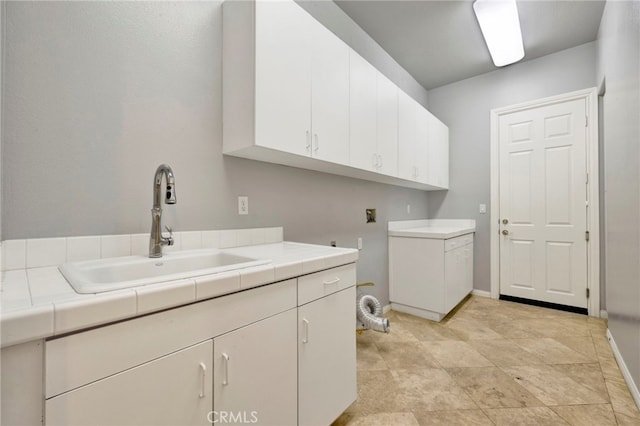 washroom featuring sink, washer hookup, and cabinets