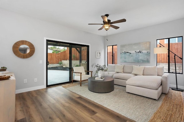 living room featuring hardwood / wood-style floors and ceiling fan