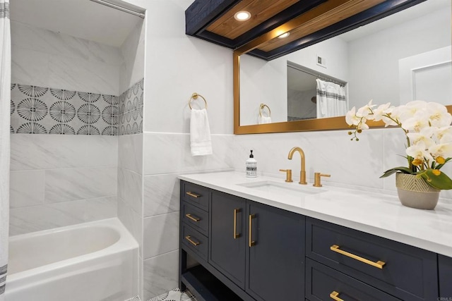 bathroom featuring vanity and tiled shower / bath combo