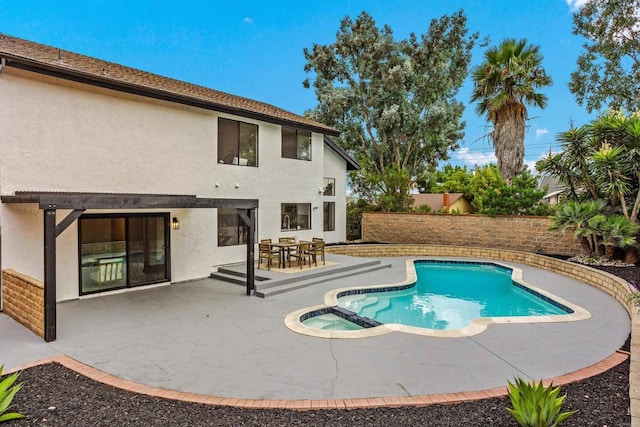 view of pool with an in ground hot tub and a patio