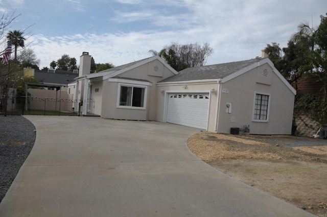 single story home featuring concrete driveway, fence, an attached garage, and stucco siding