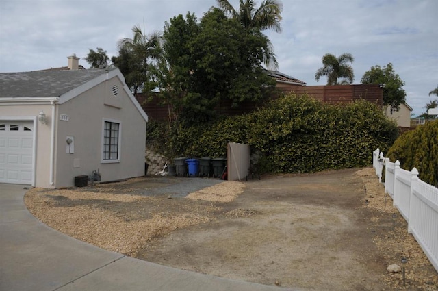 view of property exterior featuring fence and stucco siding