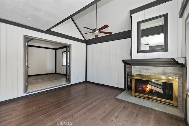 unfurnished living room with high vaulted ceiling, wood walls, ceiling fan, and dark hardwood / wood-style floors