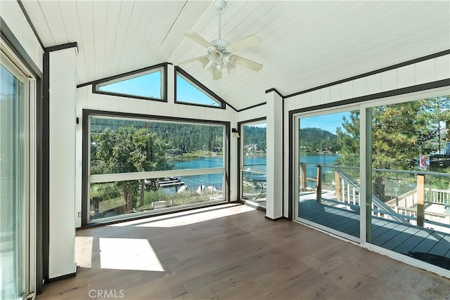 unfurnished sunroom with lofted ceiling, a water view, and ceiling fan