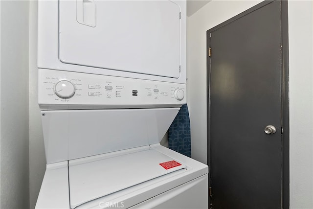 laundry area with stacked washing maching and dryer