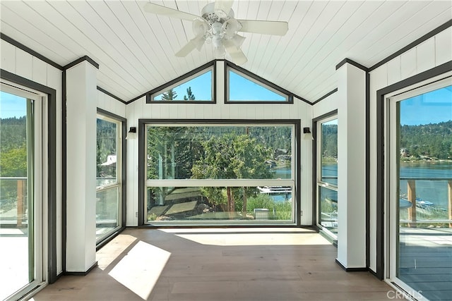 unfurnished sunroom featuring a water view, vaulted ceiling, and ceiling fan