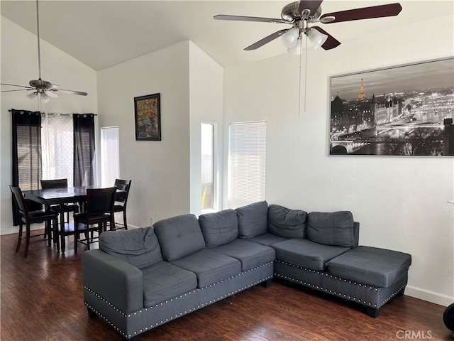 living room featuring dark wood-type flooring, ceiling fan, and a healthy amount of sunlight