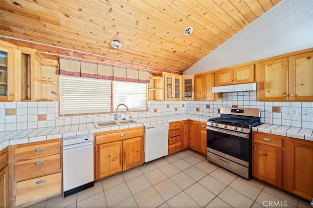 23610 W Lancaster Rd, Lancaster, CA 93536 - kitchen with white dishwasher, a sink, stainless steel range with gas stovetop, under cabinet range hood, and vaulted ceiling