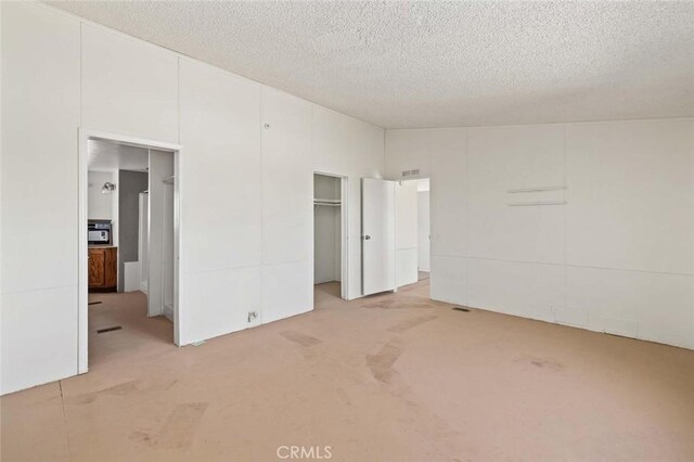 23610 W Lancaster Rd, Lancaster, CA 93536 - unfurnished bedroom with light colored carpet, a textured ceiling, and a closet