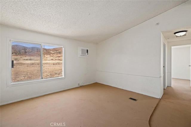 23610 W Lancaster Rd, Lancaster, CA 93536 - unfurnished room with visible vents, a textured ceiling, and a wall mounted AC