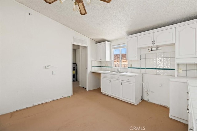 23610 W Lancaster Rd, Lancaster, CA 93536 - kitchen with white cabinets, ceiling fan, light colored carpet, and a sink