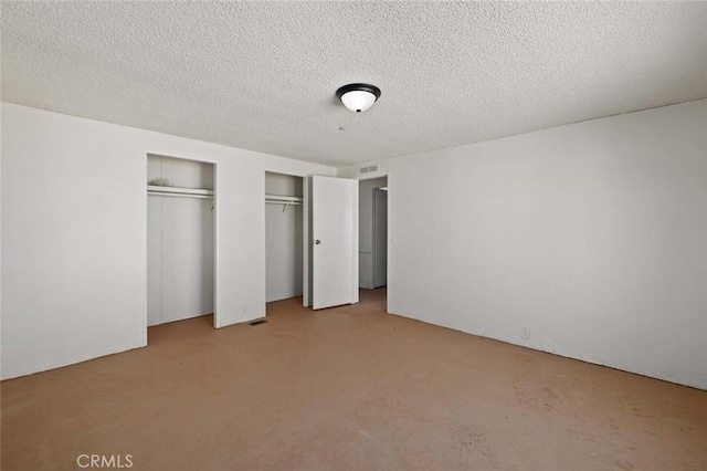 23610 W Lancaster Rd, Lancaster, CA 93536 - unfurnished bedroom with carpet floors, two closets, a textured ceiling, and visible vents