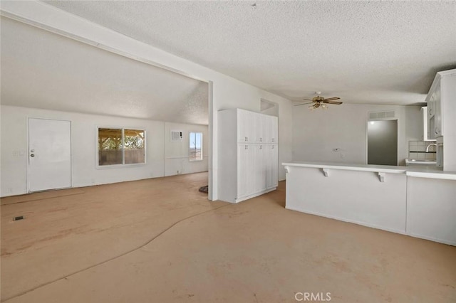 23610 W Lancaster Rd, Lancaster, CA 93536 - unfurnished living room featuring a ceiling fan, a textured ceiling, visible vents, a sink, and concrete floors