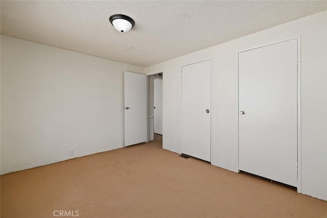 23610 W Lancaster Rd, Lancaster, CA 93536 - unfurnished bedroom with a textured ceiling and light colored carpet