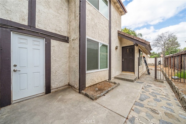 view of exterior entry featuring a patio