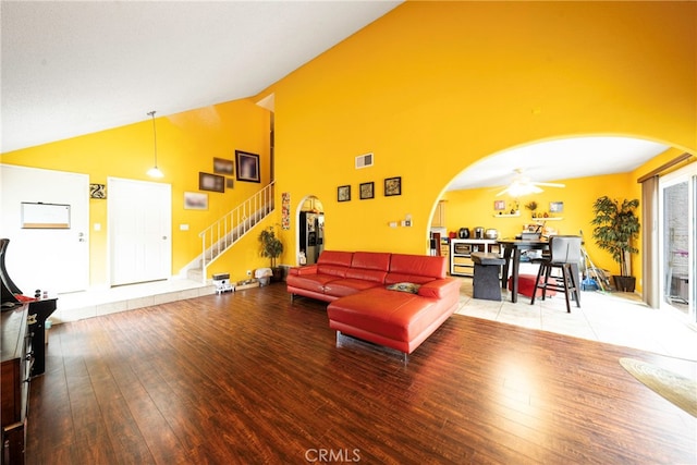 living room featuring wood-type flooring, high vaulted ceiling, and ceiling fan