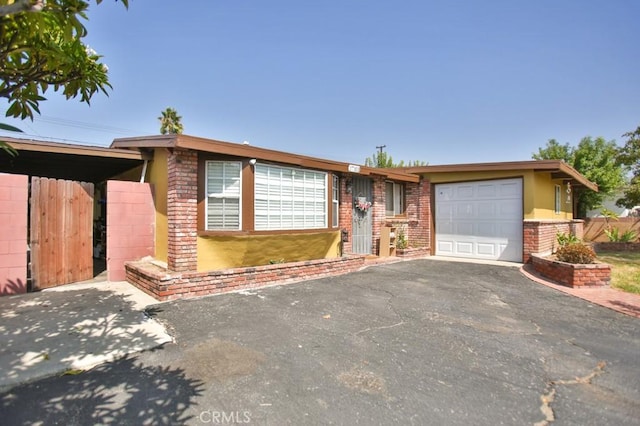 ranch-style home with a carport and a garage