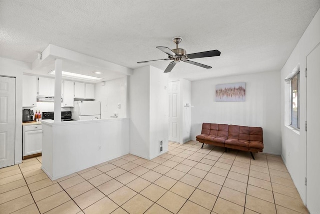 kitchen with ceiling fan, white cabinets, light tile patterned floors, and white fridge