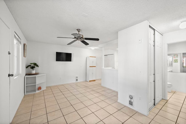 tiled spare room featuring ceiling fan and a textured ceiling