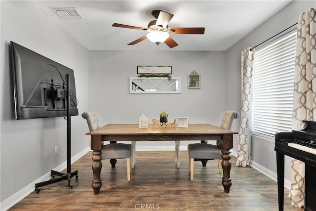 dining space featuring ceiling fan and dark hardwood / wood-style flooring