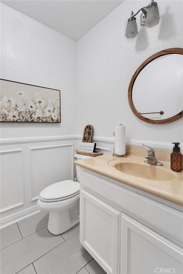 bathroom featuring tile patterned floors, vanity, and toilet