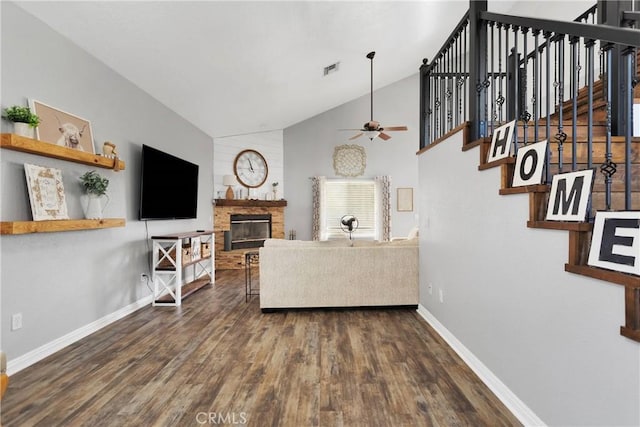 living room with ceiling fan, dark hardwood / wood-style flooring, and vaulted ceiling